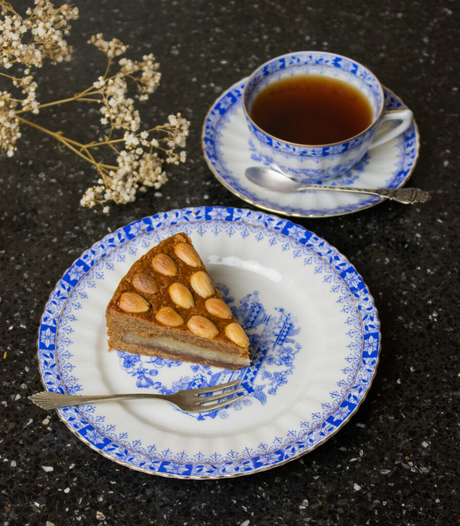 piece of almond paste filled spiced cake and cup of tea